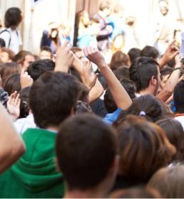 A crowd of people fill a street at a political march