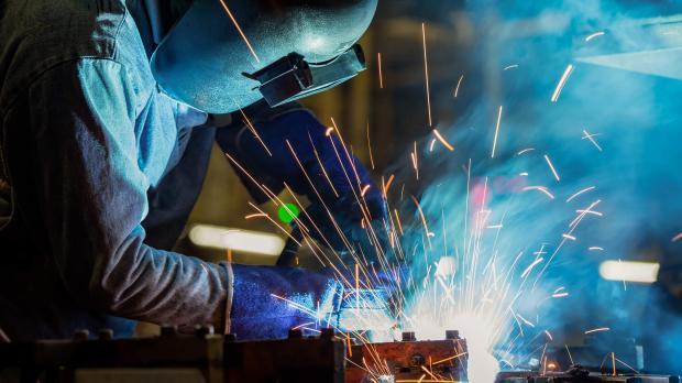 Image of someone crafting metal with sparks flying