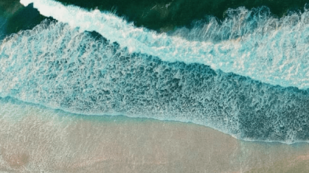 Waves breaking on a beach. View from above. Waves breaking on a beach. View from above.