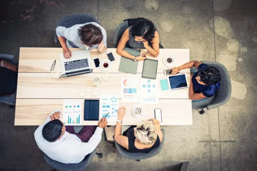A group of colleagues in a meeting, seen from above